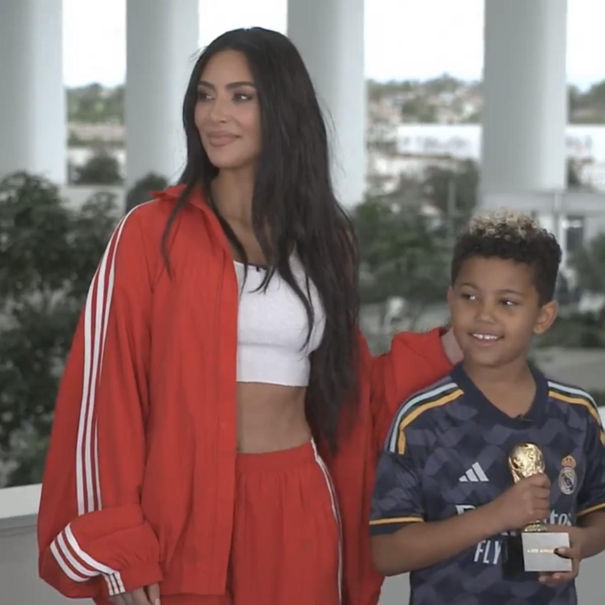 Kim Kardashian standing next to her son Saint West