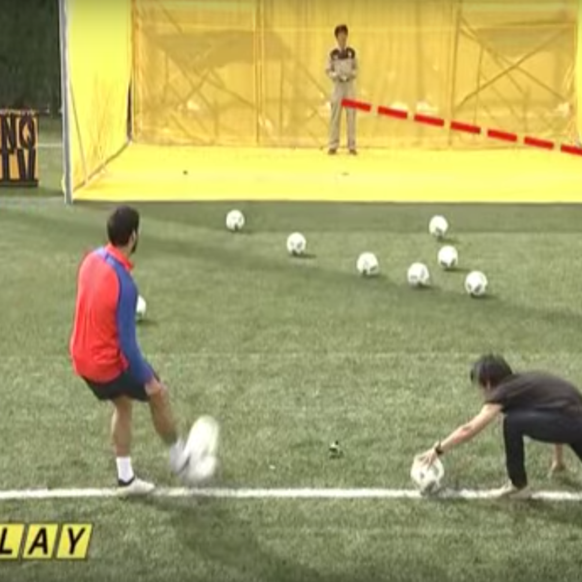 Luis Suarez and Lionel Messi kick soccer balls a drones 