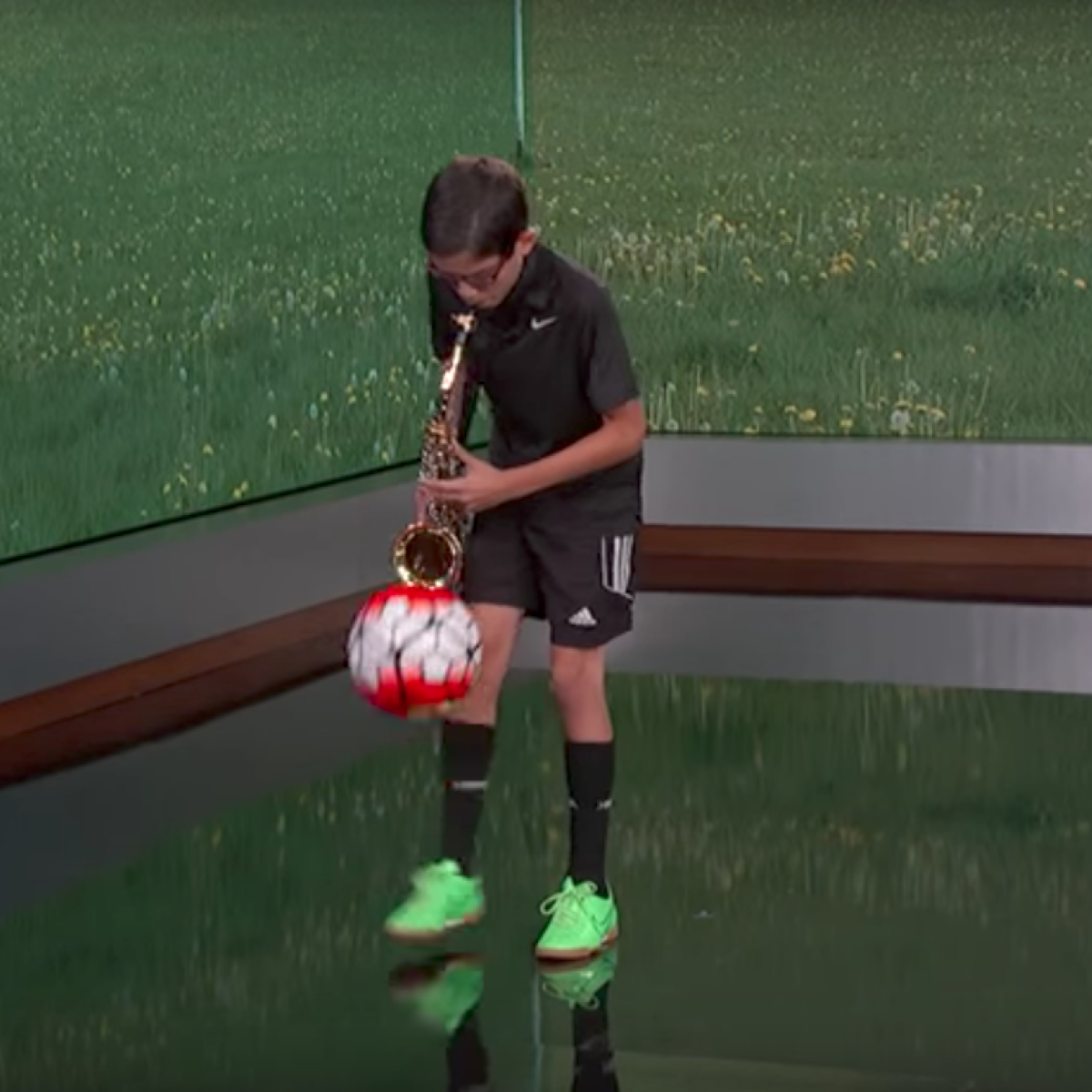 Juggling Soccer ball playing saxophone