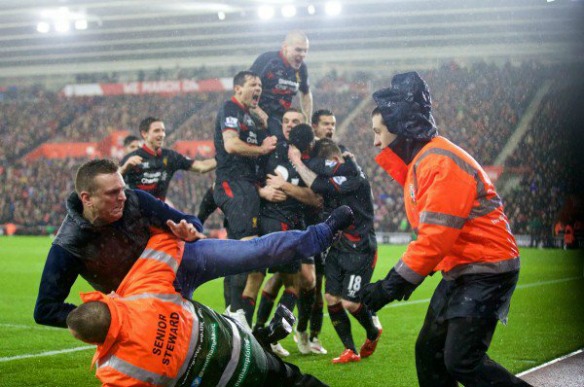 Fan runs on pitch