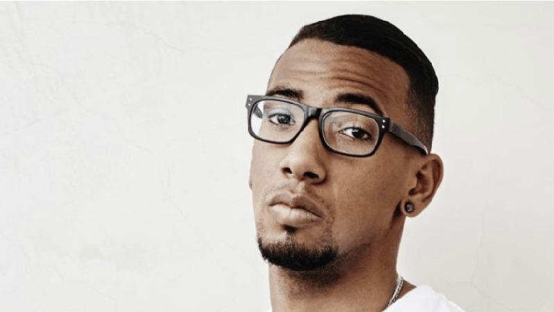 Jerome Boateng is shown in glasses looking combative yet wise. 